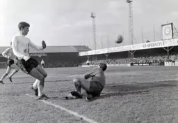 Alan Slough lifts the ball over County Keeper Mick Rose
