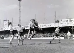 Graham French watches as Ian Buxton is beaten to the ball by Mick Rose