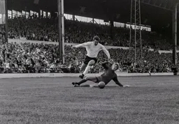 Graham French skips over Neil Hague as he attempts a tackle