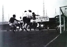Laurie Sheffield and Graham French both go for the ball