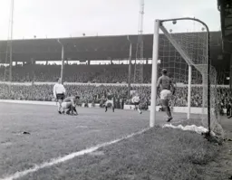 Laurie Sheffield and Ray Whittaker watch the ball drift over the crossbar