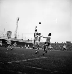 Laurie Sheffield heads the ball back to the waiting Brian Lewis