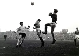 Gills keeper John Simpson punches the ball clear as Bruce Rioch runs in