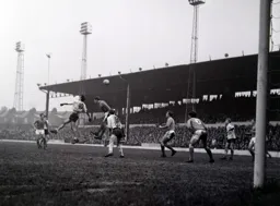 The ball goes over the head of Bruce Rioch and Ian Buxton