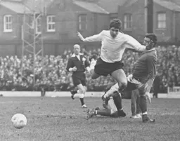 Alan Slough is clipped as he runs forward