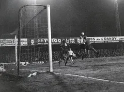Laurie Sheffield and John Phillips challenge for the ball