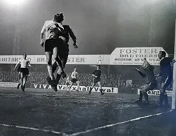 Keith Allen attempts to flick the ball on with his head