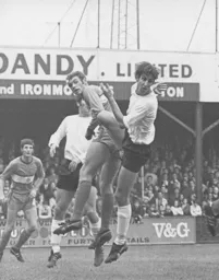 Chris Nicholl puts pressure on the Stockport defence