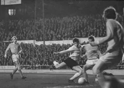 Malcolm Macdonald gets to the ball first