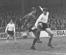 Peter Phillips gets the better of Terry Mancini watched by Graham French