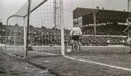 Malcolm Macdonald smiles after a John Ryan piledriver comes back out of the net