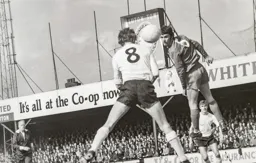 Keith Allen first to the ball