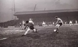 Viv Busby attempts to round the keeper