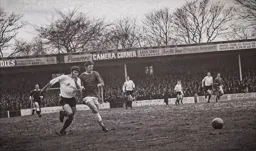 Malcolm Macdonald uses his strength to get past a defender