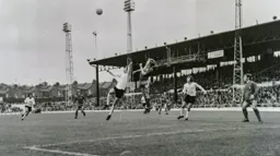 Robin Wainwright tries to knock the ball down to the waiting Peter Anderson