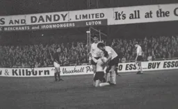Don Shanks congratulates Vic Halom for a goal against his old club.