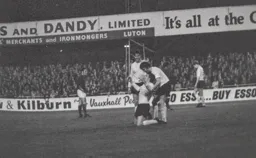 Don Shanks congratulates Vic Halom for a goal against his old club.