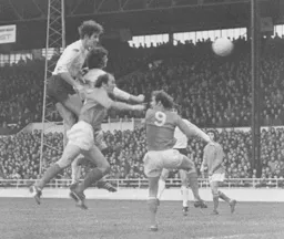 Chris Nicholl powers in a header