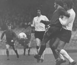 Alan Slough tries to battle through watched by Don Givens