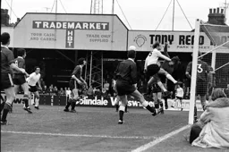 John Faulkner challenges keeper with referee keeping a close eye on attack