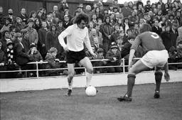 Graham French takes on the Millwall defender