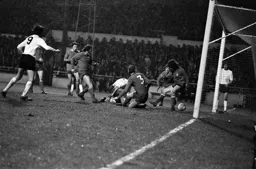 Alan Slough on the ground as the ball trickles towards the goal