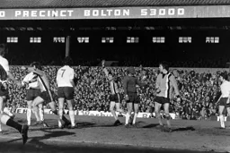 Alan Garner celebrates his goal watched by team mates John and Jimmy Ryan