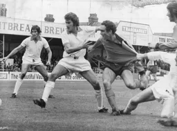 John Aston has his shirt pulled by a Blackpool defender