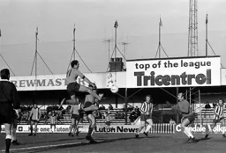 John Aston gets his head to the ball