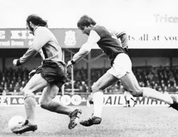 Rodney Fern goes round Chris Nicholl