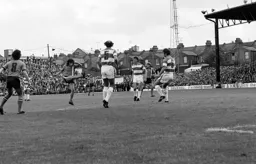 Peter Anderson shoots past three defenders