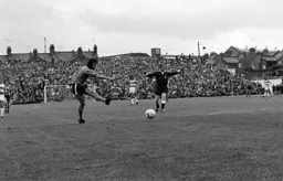 Jimmy Husband shoots as the referee waves play on