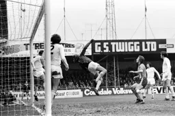 Steve Litt watches Pat Jennings tip over