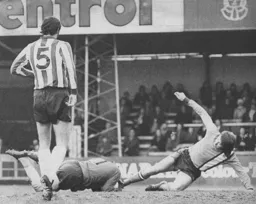 Alan West goes in on the Blades goalkeeper