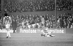 Alan West puts a Stoke defender on the floor