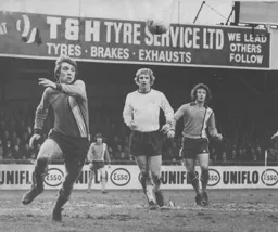 Alan West goes for the ball watched by Jimmy Husband