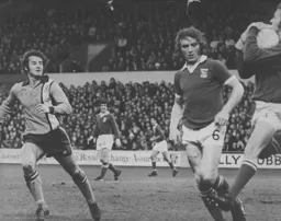 Jimmy Husband watches as the Ipswich goalkeeper safely gathers the ball