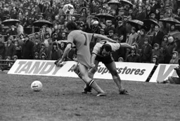 Jim Ryan still gets past the grips with the defender in the pouring rain