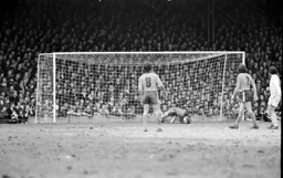 Keith Barber drops onto the ball watched by the Oak Road crowd