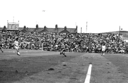 A plane overhead watches Alan West put a cross in