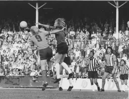 Notts keeper Eric McManus clears the ball from the head of Ron Futcher
