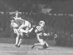 Ron Futcher is beaten to the ball by future Hatter Milija Aleksic