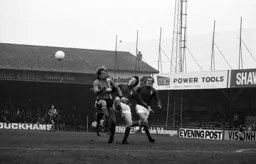 Alan West contests the ball with two Oldham defenders
