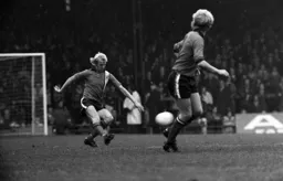 Paul Futcher clears upfield watched by his twin