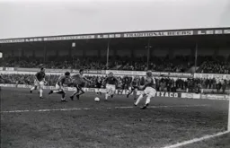 Andy King takes on three defenders