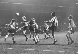 Ron Futcher gets his head to the ball