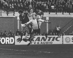 Ron Futcher in a brave attempt to win the ball