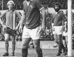 Ron Futcher waits for a corner to be delivered, watched by former Hatter Derek Hales