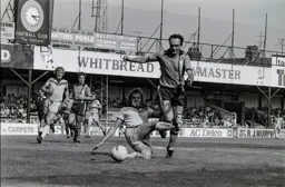 John Aston tries to ride the tackle