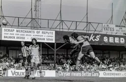 Ricky Hill gets his head to the ball first